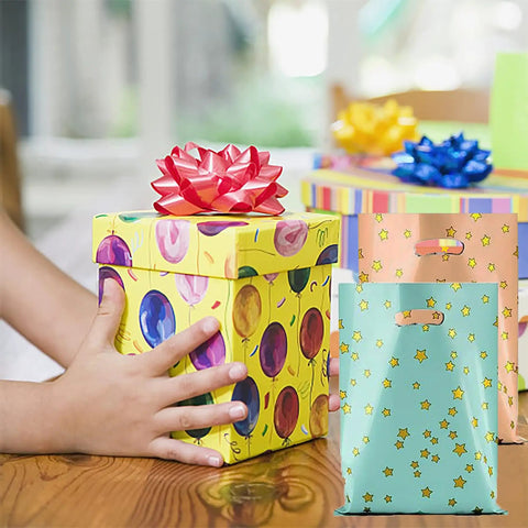 25 Party Favor Bags For Kids Birthday Parties With Star Pattern In 5 Colors next to gift boxes