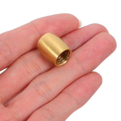 Close-up of a single brass cone-shaped foot from the 8pc Brass Furniture Legs For Wooden Trays And Boxes, shown on a hand