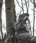 Camera Mounting Arm For Filming Hunts With Video Head No Fuss Lightweight Aluminum Build Beginner Arm For Small Cameras And Cell Phones Durable And Easy To Use Wide Range Of Motion For Smooth Shots. hunter in camo using aluminum tree-mounted camera arm with smartphone