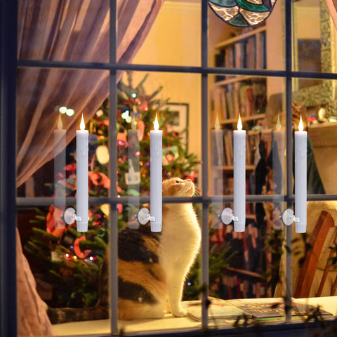 Eight Flameless Taper Candles With Remote Controls And Timer, 9.64 Inch Ivory Window Candles in front of Christmas tree and cat