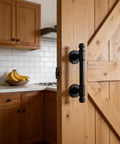Dope Industrial Pipe Barn Door Handle Set in Rustic Black Iron installed on wooden door, perfect for interior doors.