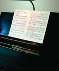 Piano with sheet music illuminated by Led T10 120V 5W Frosted Dimmable Glass Bulb 2 Pack For Piano Light And Banker Light.