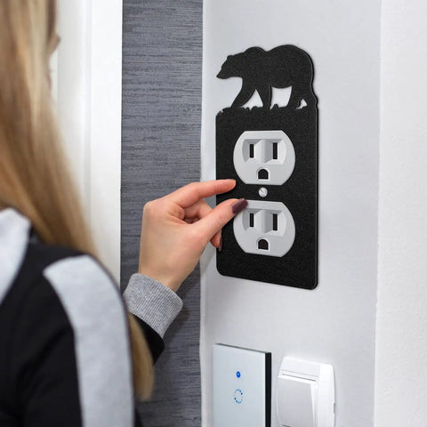 Person using Six Pack Metal Bear Light Switch Covers With Moose Tree Mountain Elk Forest Designs on a single-gang outlet.