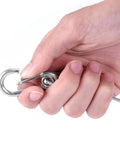Hand holding Beefy Heavy Duty 31.5 Inch Stainless Steel Stage Light Safety Cable, clip detail for easy security.