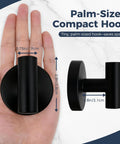 Heavy Duty Suction Hooks That Hold Firm On Glass Tile And Mirror Removable Shower Hangers With Rock Solid Vacuum Grip Easy Mount Metal Bathroom Towel Rack Four Pack Black shown palm-sized compact hook next to hand for scale.
