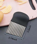 Close-up of black-handled stainless steel crinkle cutter with a 5.5-inch blade on a pink cutting board.