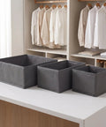 Super Sturdy Foldable Drawer Clothing Organizer Set Eight Piece Gray Fabric Wardrobe Dividers arranged on a table