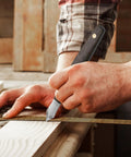 Badass Woodworking Marking Knife Built Tough With A Razor Sharp Double Bevel Blade And Slick Leather Sheath For Precise Layout Marks in use on wood.