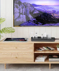 Living room setup with a Workhorse Heavy Duty Surge Protector Power Strip With 6 Foot Extension Cord And 10 Outlets Plus 4 USB Ports And USB C Port, 2700 Joules, ETL Listed, Ideal For Home Office Dorm Essentials, Black, on a wooden cabinet.