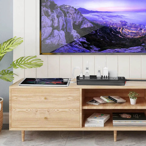 Living room setup with a Workhorse Heavy Duty Surge Protector Power Strip With 6 Foot Extension Cord And 10 Outlets Plus 4 USB Ports And USB C Port, 2700 Joules, ETL Listed, Ideal For Home Office Dorm Essentials, Black, on a wooden cabinet.