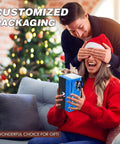 Man surprising woman with an Electrical Automatic Rolling Machine Mini Injector gift on a couch, Christmas tree in background.