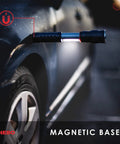 Slide Out COB Work Light And Flashlight With Strong Magnetic Base attached to car metal surface for hands-free use.