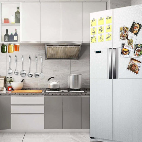 Kitchen scene with a fridge displaying notes secured by Six Pack Super Strong Neodymium Disc Magnets With Double Sided Adhesive.