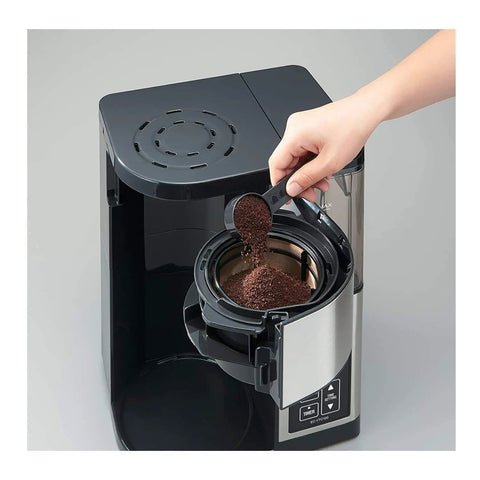 10 Cup Coffee Maker With Fresh Brew Plus Thermal Carafe Delivers Hot Coffee At 200 Degrees Fahrenheit Easy Setup For Strong Or Concentrated Ice Brew Stainless Steel And Black Finish A Real Game Changer being filled with coffee grounds.