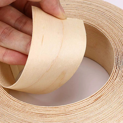 Hand holding Maple Wood Veneer Edge Banding, 2 Inch By 50 Foot Roll, Preglued Iron On Edgebanding With Hot Melt Adhesive