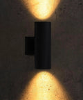 Outdoor Cylinder Wall Lights 12 Inch Up Down Sconce For Porch And Patio Matte Black Weatherproof Aluminum Exterior Light Fixture With E26 Base ETL Certified Pack Of 2 shown illuminating wall surface with warm light