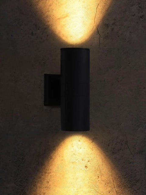 Outdoor Cylinder Wall Lights 12 Inch Up Down Sconce For Porch And Patio Matte Black Weatherproof Aluminum Exterior Light Fixture With E26 Base ETL Certified Pack Of 2 shown illuminating wall surface with warm light
