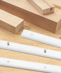 Four Piece Crosscut Sled Kit For Table Saw With Predrilled Holes, UHMW sliders on wooden surface, showing screws and miter bars.