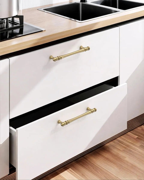 Top Shelf Brushed Brass Cabinet Handles 5 Inch Kitchen Pulls on white drawers in modern kitchen setup.