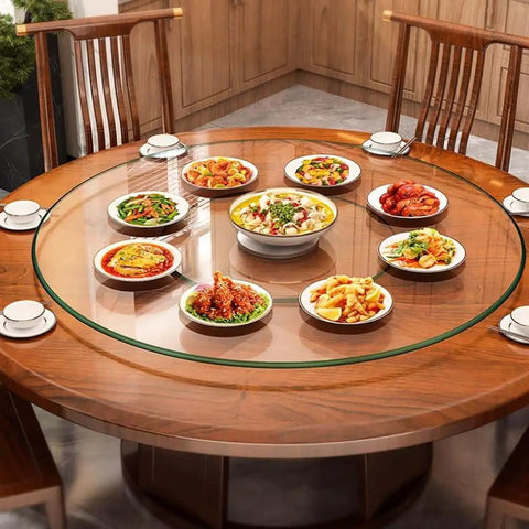 Heavy Duty Tempered Glass Lazy Susan Turntable Rock Solid Smooth Glide Kitchen Workhorse Serving Tray For Banquets And Home Tables Crystal Clear Scratch Resistant 39 Inches with several dishes on a wooden dining table.