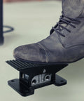 Five Way Three Position Center Closed Pneumatic Foot Pedal Valve with Leak Proof Zinc Alloy Body, black rocker style, in use