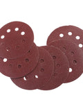 Super Tough 5 Inch Hook And Loop Sanding Discs With Eight Holes For Dustless Vibes arranged in a stack, designed for effective surface conditioning.