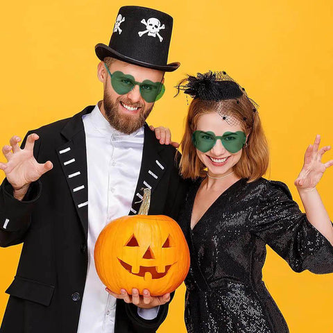 Two people wearing Heart Shaped Neon Green Sunglasses For Women And Men Unisex Rimless Glasses at a Halloween event.