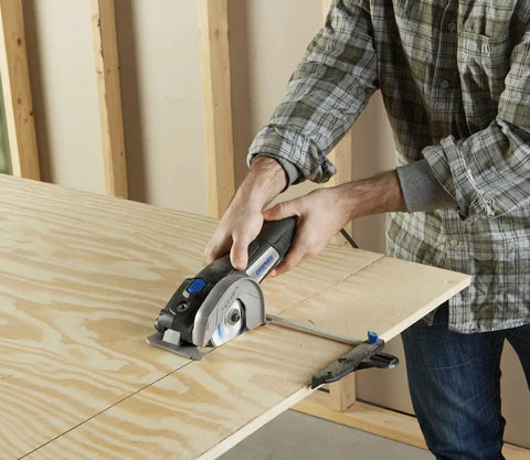Person using Ultra Saw Corded Compact Saw Tool Kit With 3 Cutting Wheels And Auxiliary Handle on wood board for precise DIY cuts.