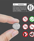 A hand holding an LR44/AG13 battery displaying warning labels for No Fuss No Muss Heavy Duty Performance Lr44 Ag13 Batteries 20 Pack Snappy 1.5 Volt Alkaline Button Cells.