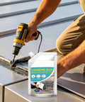 A worker using a drill to apply Heavy Duty Concrete Crack Filler Waterproof Self Leveling Sealant on a metal surface.