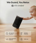 ETL certified black ceramic space heater with tip-over protection being touched by a baby, highlighting safety features.