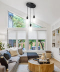 Sleek 3 Light Cluster Pendant In Black With Clear Glass Shades Adjustable Vintage Hanging Light For Kitchen Island Dining Room Foyer And Hallway E26 Base Fixture in modern living room.