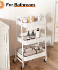 White 3-Tier Rolling Utility Cart With Locking Wheels For Small Spaces in bathroom holding toiletries and towels
