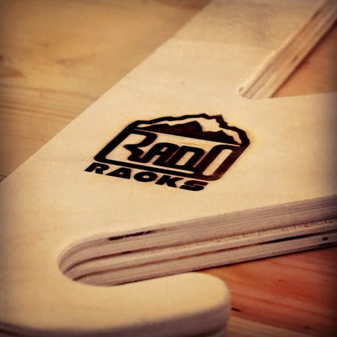 Premium Baltic Birch Wall Mount Snowboard Rack And Ski Holder For Four Boards logo detail on the wood surface
