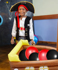 Child standing in an inflatable pirate ship cooler for pool parties and Gasparilla decor, with balloons inside as food tray and beverage holder.