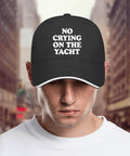 No Crying On The Yacht Golf Hat For Men shown on a model, cool lightweight black cap with classic silhouette and bold text design.