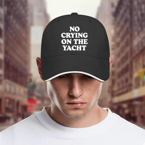 No Crying On The Yacht Golf Hat For Men shown on a model, cool lightweight black cap with classic silhouette and bold text design.