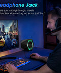 User gaming with Powerful 50W Gaming Desktop Speakers With Infinity Mirror 3D Tunnel RGB Lighting next to monitor
