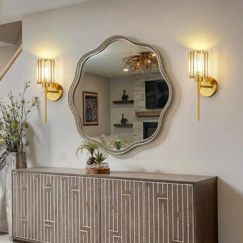 Two Pack Crystal Rechargeable Wireless Wall Sconces Featuring Brushed Gold Finish With Adjustable Dimming Remote And Multi Hue Settings Built For Super Quick Mounting And Zero Wiring Hassles Ever, displayed beside a decorative mirror.