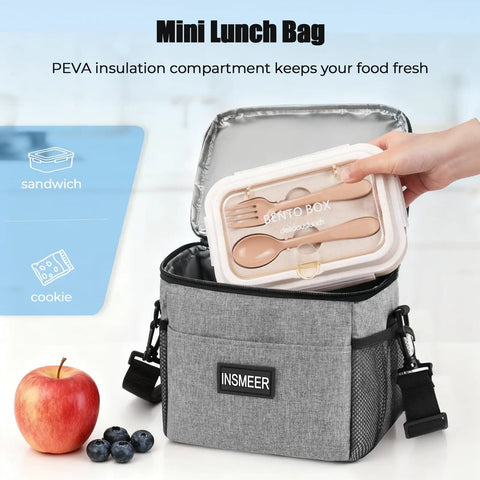 Hand placing bento box into gray mini lunch bag with PEVA insulation, part of Rolling Cooler With Mini Lunch Bag 50 Can Capacity Collapsible