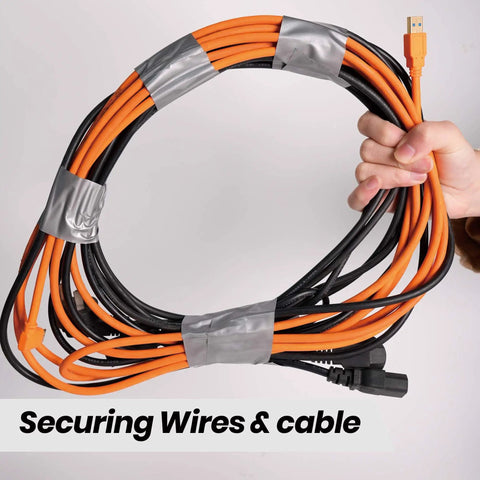 Hand holding cables secured with Heavy Duty Duct Tape 1 Point 88 Inch Wide By 90 Feet Waterproof No Residue Hand Tear Bond.
