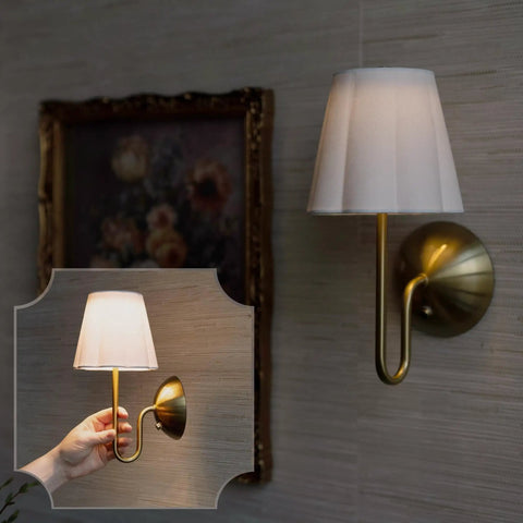 BSFHKLA Cordless Rechargeable Wall Sconce with Scalloped Fabric Shade and Remote, Brass Finish, USB, Dimmable LED Lighting(WhiteVelvet) in use with hand holding lamp.