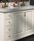 Bathroom vanity with Six Pack 3 Inch Hole Center Cabinet Pulls Antique Brass Zinc Alloy Drawer Handles installed on white cabinet.
