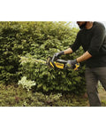 Person using 20V Max 22 Inch Cordless Hedge Trimmer Bare Tool Only With Up To 78 Minute Runtime Powerhouse Motor for cutting branches