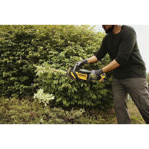Person using 20V Max 22 Inch Cordless Hedge Trimmer Bare Tool Only With Up To 78 Minute Runtime Powerhouse Motor for cutting branches