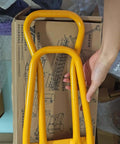 HTSL25E2 Roof Eaves Seam Bender, yellow crimper tool for standing seam metal roofing, hand holding tool above packaging.