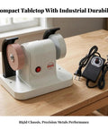 Solid Dual Wheel Bench Grinder And Compact Polishing Rig With Copper Motor Blade Sharpener Tool Honer sitting on a wooden table.