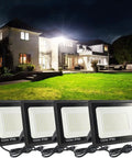 4 Pack 100W LED Flood Lights Outdoor, 11000 Lumen Super Bright Work Light With 6 Ft US Plug, IP66 Waterproof Exterior Security Lighting, 6000K Daylight White Slim Floodlights illuminating a house and yard at night.
