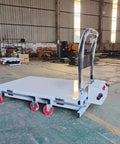 Heavy Duty Hydraulic Forklift And Electric Scissor Lift Table With Four Wheel Elevating Platform for cargo handling with wheels in warehouse.