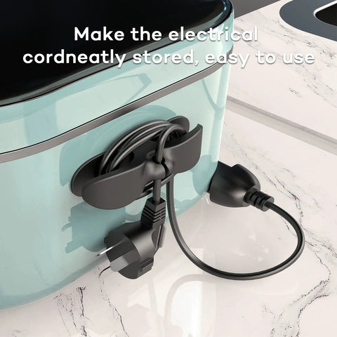 Four Pack Cord Organizer For Appliances And Kitchen Cords, Sticks Firmly With High Temp Silicone on a kitchen appliance, black.